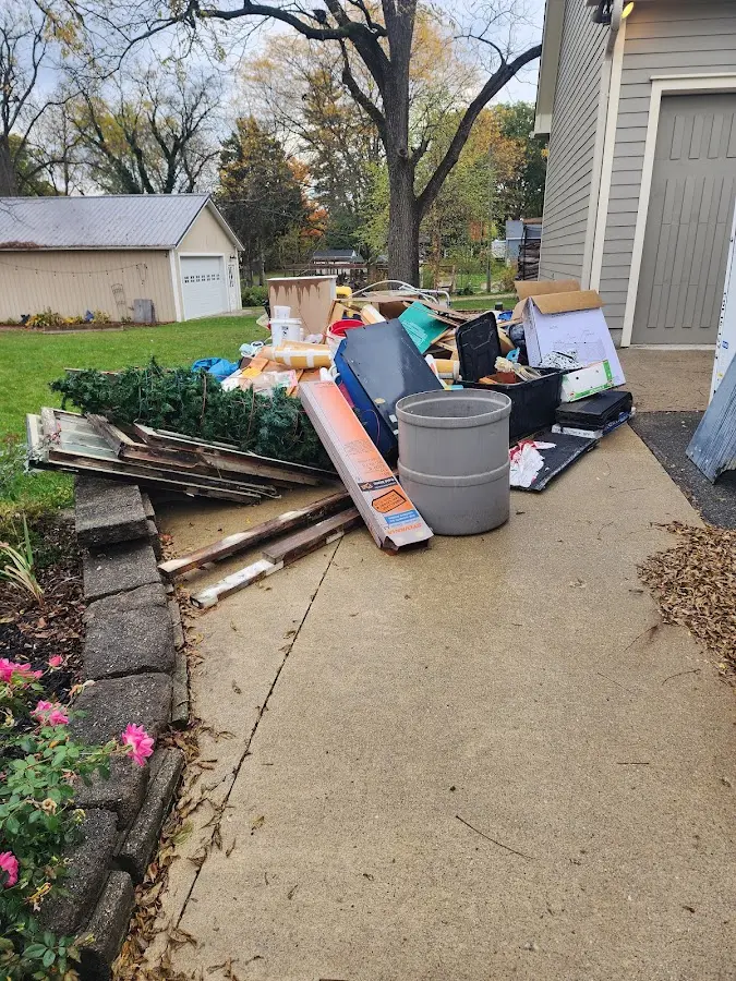 Dumpster being loaded with debris for Residential Dumpster Rental in Cedar Rapids